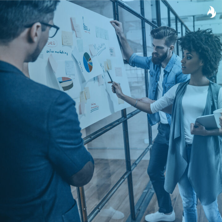 News thumbnail of three people looking at data on a whiteboard